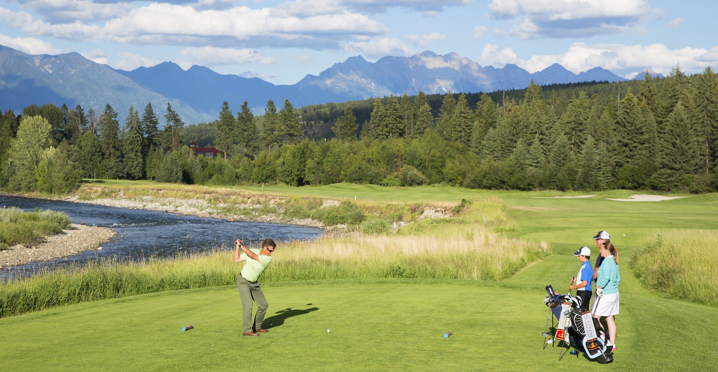 Golfer teeing off on 9th hole